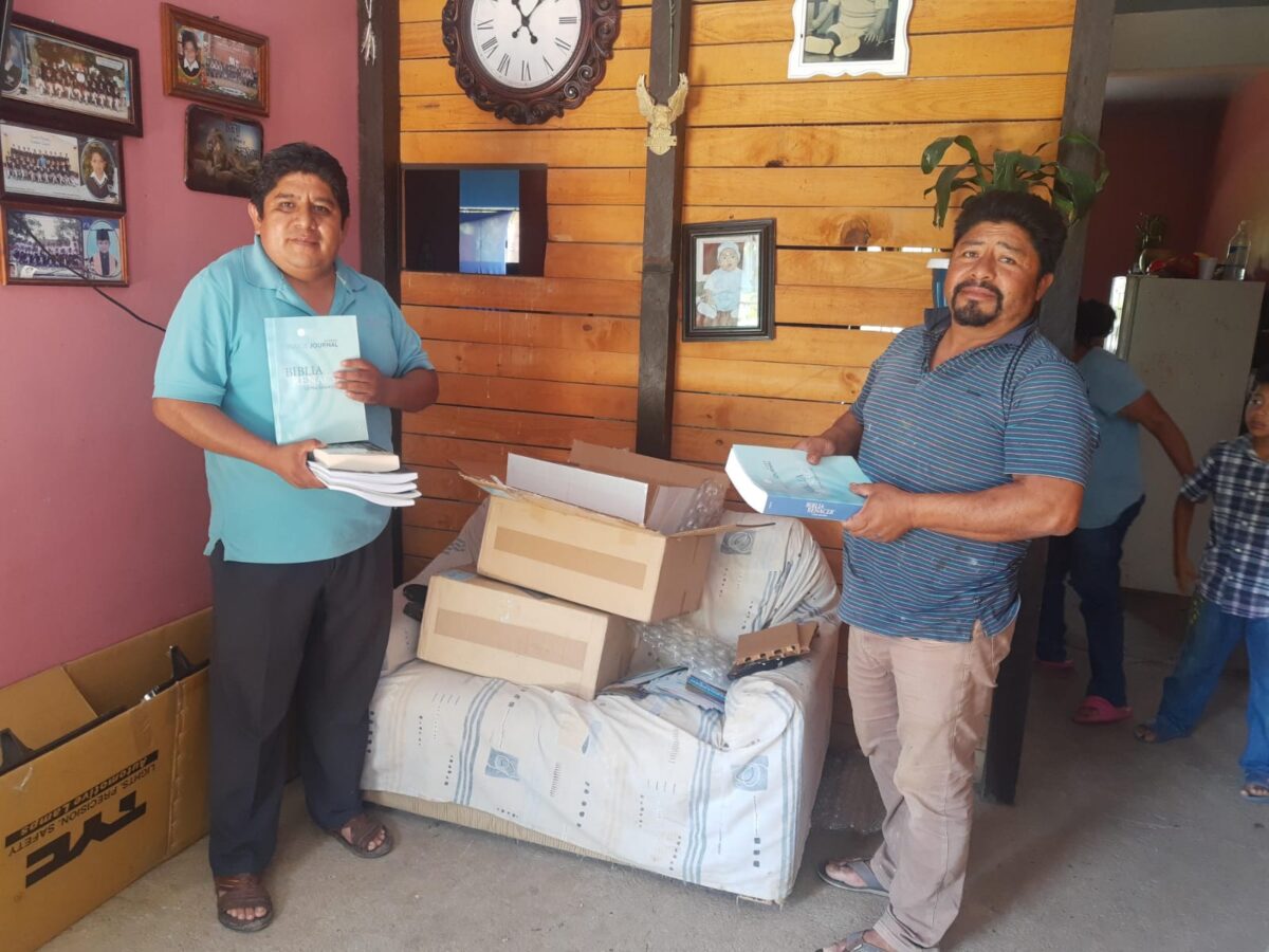 Two men unpack bibles for the prison ministry in Mexico, Sembrando Palabra de Libertad.